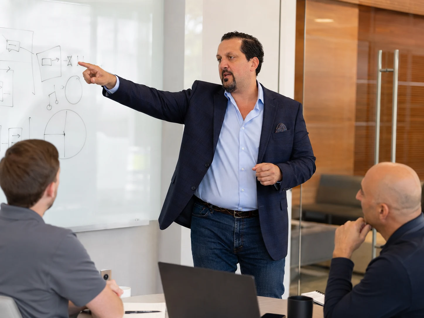 Tony Kurtulan explaining a practical sales coaching process at a whiteboard